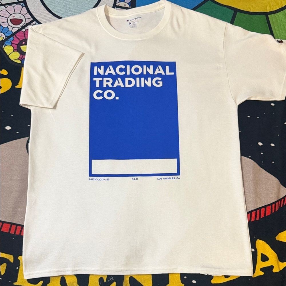 Champion Cream T-Shirt with Blue "Nacional Trading Co." Graphic